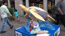 Tusk Turtle Trail - girl in Ukranian flower wreath enjoys bright colours of Teddy the Turtle in Covent Garden