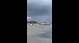 Waterspout forms off the shore as storm passes through beach in Galveston, Texas