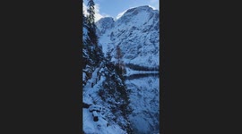 Snowy Mountains Reflected in Crystal-Clear Alpine Lake
