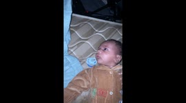 Baby outraged by his dad's loud snoring