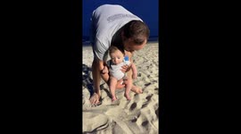 Baby’s first steps in the sand in Myrtle Beach, South Carolina, USA