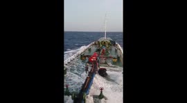 Sea crashes onto deck of tanker ship as it navigates tropical waters