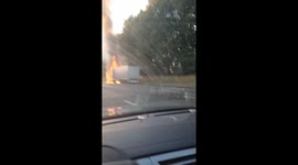 Truck's tyre explodes as motorist drives past vehicle engulfed in flames on Belgian highway