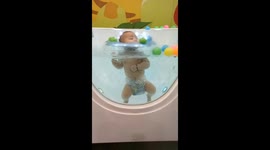 Too Cute! Little One Floating Calmly in Baby Spa