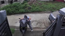 Motorcycle rider pinned to the ground as she tries to roll bike down the driveway