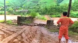 Bridge swept away by river as heavy rain triggers floods in Vietnam