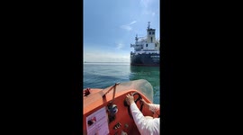 Crew manoeuvres lifeboat and rescue boat through the waters during training exercise