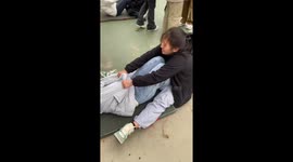 Supportive girl helps friend during sit-up test at university