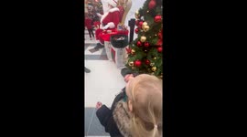 Santa Claus receives an unexpected present from an adorable little girl