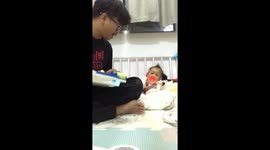 Baby plays toy trumpet with her dad