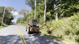 tractor cutting the grass on the side of the road in Pownal Vermont