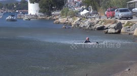 Tourist BLOWN into the sea by jet blast at Skiathos Airport in Greece