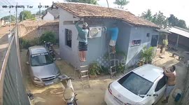 Worker dangles from roof as ladder slips away during repairs