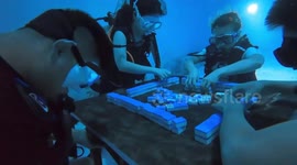 Divers play mahjong underwater in China