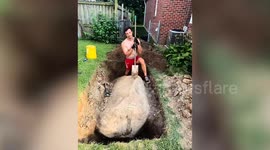 Dad starts digging up 'tiny rock' - finds it's 10,300lbs prehistoric boulder