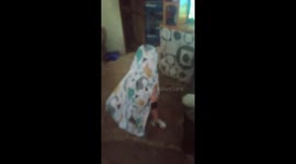 Adorable moment toddler plays peek-a-boo with his mother