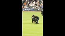 Stumbling Fan Escorted Off Baseball Field