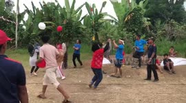 Participant falls into muddy hole during balloon game in Medan, Indonesia