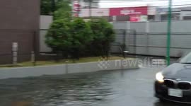 Flooded roadway slows traffic on Route 283 in Ichikawa, Chiba, Japan