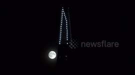 A close-up of the September Full Moon, known as the Corn Moon, as it is seen rising in the skies of London as it passes the Shard