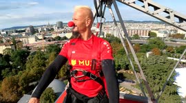 Daredevil rides Vespa atop huge Ferris wheel in scary world record attempt