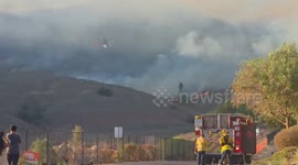 Helicopter water drop during Pyrite Fire containment in Riverside, California