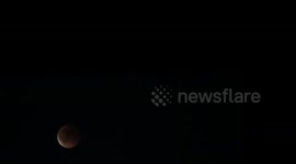 Blood moon seen above Stockholm skyline