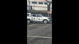 Cheerful traffic cop dances as he directs cars in rush hour