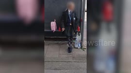 Man dressed in schoolgirl uniform and carrying pink rucksack sparks parental alarm