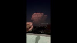 Towering lightning storm cloud illuminates the night sky in Fateh Jhang, Pakistan