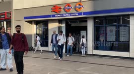 passengers rush out of lioness line in Wembley Central to take buses.