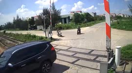 Truck crashes into train barrier on level crossing in Vietnam