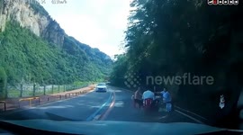 Bizarre moment locals set up dining table in middle of busy road, blocking traffic in China