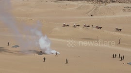 Military paratroopers perform jump over Pyramids Of Giza
