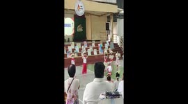 Boy helps classmate with slippers during dance performance in Manila, Philippines