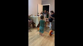 Young boy shows strength lifting barbell in Brasília, Brazil