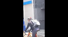 Dog on Owner's Back Riding a Bike