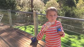 Young boy mesmerised by soap bubble