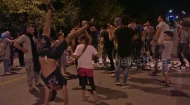 Refugees dance during protest at German Consulate in Thessaloniki