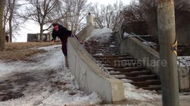 Man attempts to grind handrail on skis, hurts himself