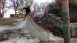 Man attempts to grind handrail on skis, hurts himself