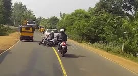 Motorcyclist has nasty accident and narrowly avoids oncoming traffic