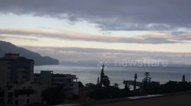 Sun hides behind Madeira island and clouds
