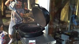 Stoking BBQ flames using a leaf blower