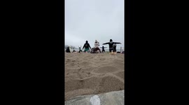 Man Takes a Nap During Sunday Morning Beach Yoga