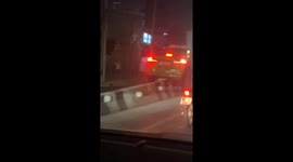 Taxi seen stuck on concrete road barrier
