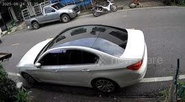 Quick-thinking motorcycle rider jumps onto car bonnet to avoid being crushed