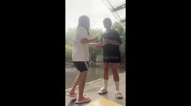 Friends slip on damp stairs amid rainfall