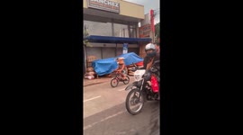 Cyclist rides with a bird box on his head as a helmet
