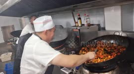 Chef’s exaggerated wok shaking during huge cooking in Jilin, China